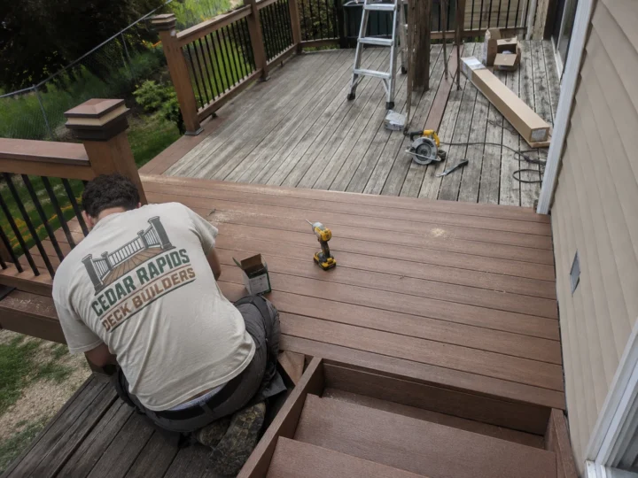 Installing brown composite deck stairs in Cedar Rapids, Iowa