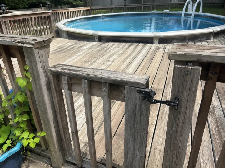 Weathered pool deck gate and railing in Cedar Rapids, Iowa
