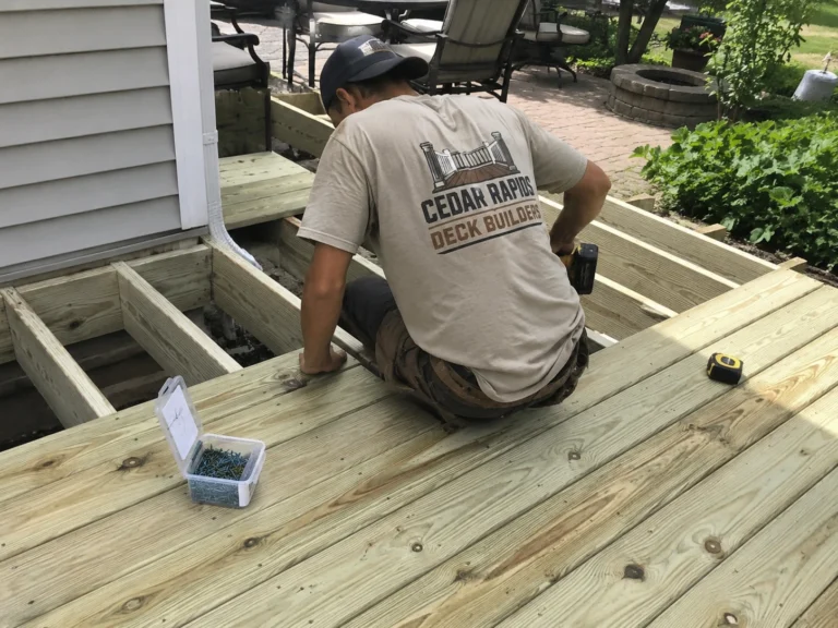 Installing new pressure treated deck boards in Central City, Iowa